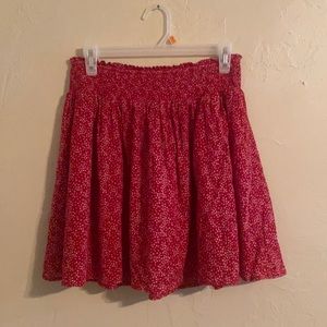 Knee length red skirt with white stars.